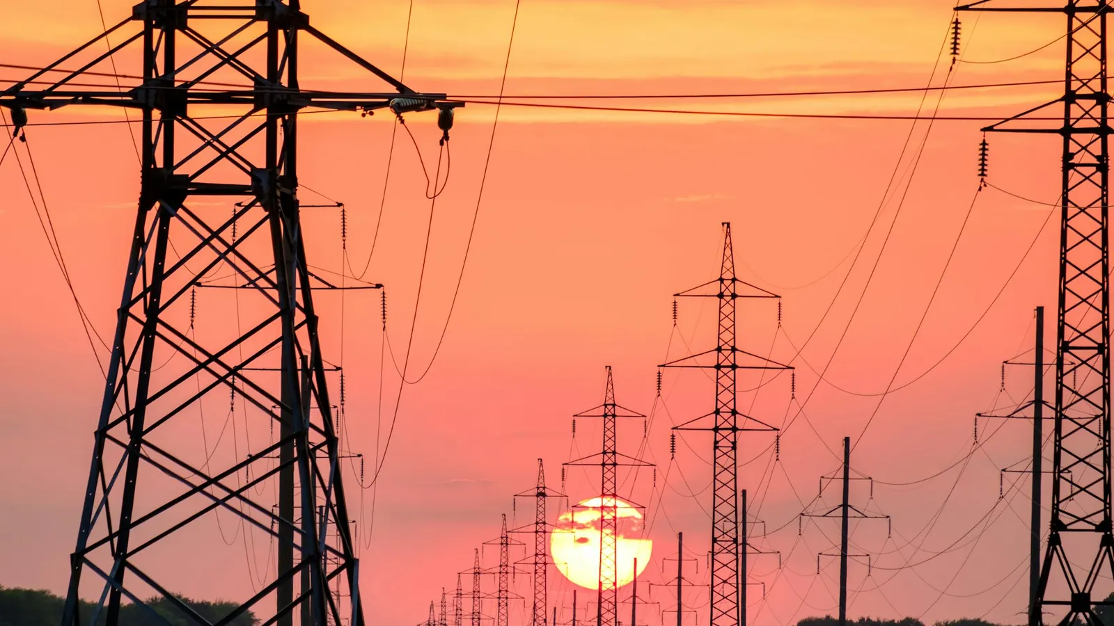 High-voltage pylons at sunset