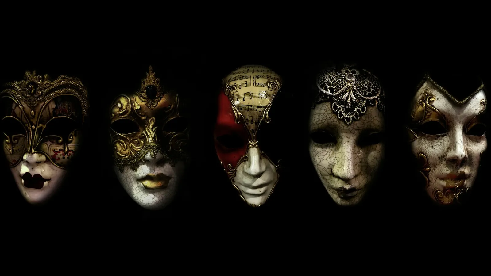 A row of Venetian masks on a black background